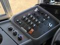 The control panel of a 2009 International 3000 CE featuring various switches and knobs for operational functions