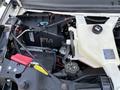 A 2019 Chevrolet Express engine compartment showing the battery, coolant reservoir, and various wires and components