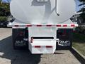 Rear view of a 2014 Freightliner M2 106 truck featuring a large white tank and a red hose attachment on the back panel