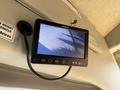 A monitor displaying a camera feed mounted on the interior of a vehicle