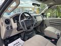 Interior view of a 2010 Ford F-550 Super Duty showing the dashboard steering wheel and seating area with a focus on the driver's side