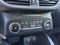 The dashboard controls of a 2020 Ford Escape featuring climate control settings and a USB port