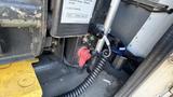 Close-up view of the interior components of a 2021 Ford Transit showing switches and cables near the driver's area