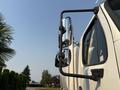 A 2016 Freightliner M2 106 truck with a prominent side mirror and a sturdy support arm for enhanced visibility