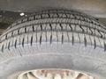 A close-up of a tire from a 2010 Ford Econoline showing detailed tread patterns and wear on the surface