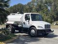 A white 2014 Freightliner M2 106 water tanker truck with a rounded tank and chrome wheels stands in a parking area