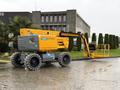 A 2020 Haulotte HA61 LE PRO aerial lift with large yellow extendable arm and platform mounted on a wheeled chassis