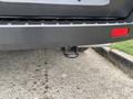 A 2020 Ford Transit 250 with a hitch receiver attached at the rear bumper