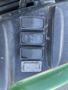 Close-up of control buttons on a John Deere 3320 300X tractor featuring three main buttons labeled SET RESET and a graphic symbol