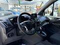 Interior view of a 2021 Ford Transit Connect showing the steering wheel dashboard and center console with various controls and a small display screen