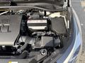 An engine compartment of a 2021 Toyota C-HR showing the battery and various fluid reservoirs and components