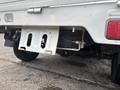 A rear view of a 2008 Suzuki Carry showing the undercarriage tire, hitch, and part of the truck's frame
