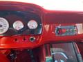 Interior dashboard of a 1962 Ford 2WHDR featuring red accents carbon fiber panels gauges and a control panel with switches and a start button
