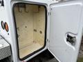 Open door of a 2018 Ford F-550 service truck revealing an empty interior with hooks and a smooth surface