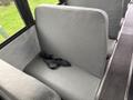 Interior seating of a 2022 Freightliner B2 bus with a gray fabric seat and a black seatbelt visible