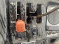 Close-up of the control panel of a 2010 Kubota RTV 900 featuring gear shift levers for 4WD and 2WD with a bright orange knob and various switches and indicators