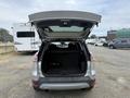 A 2014 Ford Escape with the rear hatch open revealing a spacious cargo area that is empty and lined with dark material