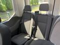 Interior seating area of a 2025 Ford Transit T-350 with three fabric-covered seats featuring seatbelts