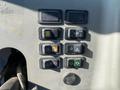 The control panel of a 2015 Bobcat 5600 featuring various buttons including lights engine and hydraulic controls