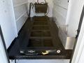 Interior view of a 2009 Ford F-550 with a metal frame and black flooring designed for cargo transport