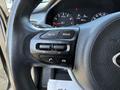 Close-up view of the steering wheel controls in a 2018 Kia Rio5 including volume and mute buttons along with a mode button