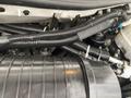 A 2020 Chevrolet Express engine with visible black hoses wiring and components including a cylindrical part and a canister