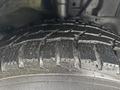 Close-up of a wet tire with deep treads showing details of the rubber and grooves on a 2021 Ford Transit-350