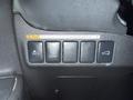 Control panel featuring five buttons including icons for traction control, lane departure warning, and trunk release in a 2016 Mitsubishi Outlander