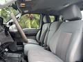 Interior view of a 2013 Ford F-250 SD showing the front seats and dashboard with gray fabric upholstery and a simple layout