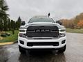 A front view of a white 2024 RAM 5500 heavy duty truck featuring a bold grille and prominent headlights