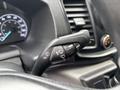 Close-up of a control stalk in a 2020 Ford Transit 250 featuring turn signal and windshield wiper controls