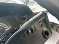 A black gear shift lever is prominently displayed in the foreground of the dashboard of a 2018 Ford Econoline with gauges and control buttons visible