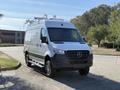 2023 Mercedes-Benz Sprinter 2500 van with a silver exterior and roof rack tires designed for enhanced traction and stability