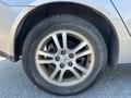 A close-up of a silver 2006 Pontiac G6 wheel with a multi-spoke alloy rim and a black tire