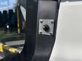 A close-up of a metal connection plate with a black toggle switch mounted on the side of a 2018 Ford Transit-350