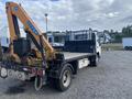 A 2019 Hino 195 flatbed truck with a mounted crane arm in the rear loaded with equipment
