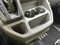 Close-up of the center console of a 2023 Ford Transit featuring cup holders and controls for various functions