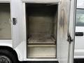 A 2017 Ford F-350 SD with an open utility truck compartment displaying empty shelves and a clean interior space