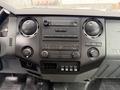 Dashboard of a 2015 Ford F-350 SD featuring climate control knobs a radio display and various buttons for controls