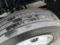 A close-up of a tire from a 2019 Hino 195 showing tread patterns and wear with a focus on the rubber surface and rim