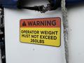 A warning label on a 2015 Freightliner M2 indicating that operator weight must not exceed 260lbs