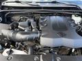 The image shows the engine compartment of a 2021 Toyota 4Runner featuring a large engine cover and various components including hoses and pipes