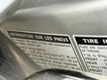 A close-up view of a 2016 Yamaha FJR1300AE motorcycle's tire pressure information label in English and French