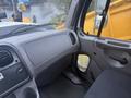 Interior view of a 2016 Freightliner 108SD showing the driver's side dashboard and seat with a simple gray design and controls