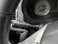 Close-up of the steering wheel and dashboard controls of a 2016 Subaru Forester focusing on the multifunction lever for lights and wipers
