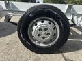 A close-up of a steel wheel and tire from a 2023 RAM Promaster 3500 featuring a silver rim and a black tire with the brand name Roadian