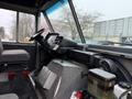 Interior view of a 2012 Ford Econoline showing the driver's seat steering wheel and dashboard with various controls and displays