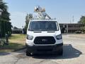 A 2019 Ford Transit 350 van with a raised utility crane on top is facing directly towards the viewer