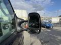 Side view mirror of a 2011 Ford Econoline van featuring a rectangular design and silver trim