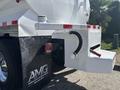 A 2014 Freightliner M2 106 truck featuring a white body a visible exhaust pipe and a black mudflap with the logo of Abenante Motor Group